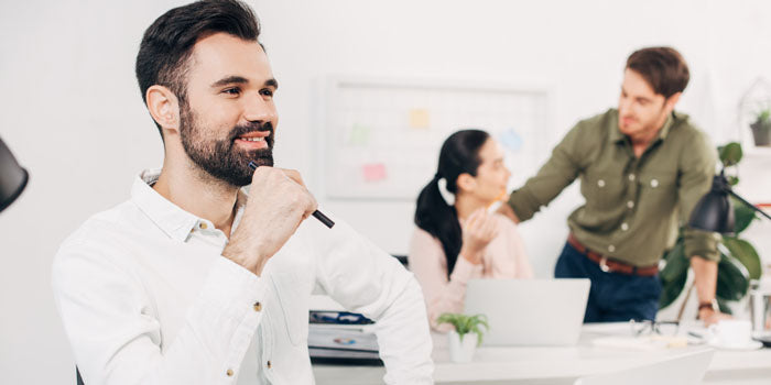 man smiling in a class or office