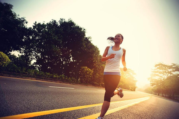 women runs on the side of a road