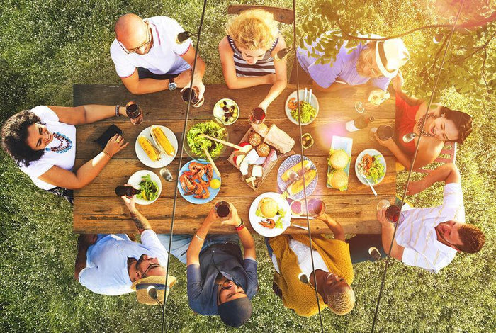 friends gather around a table to eat together